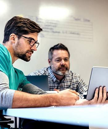 Kontakt two men working with a tablet