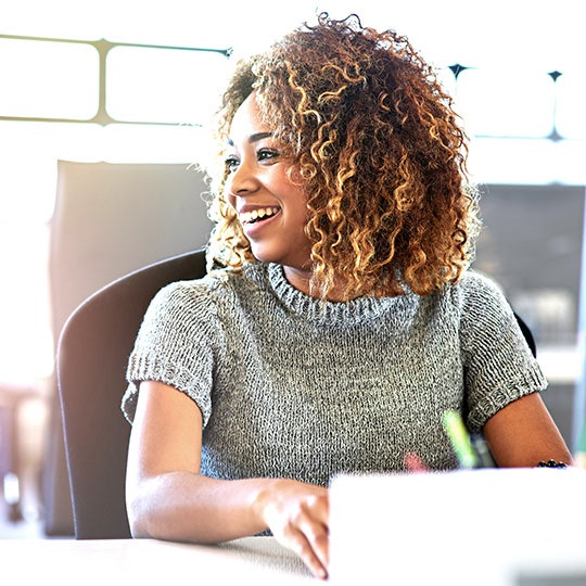 woman smiling and working