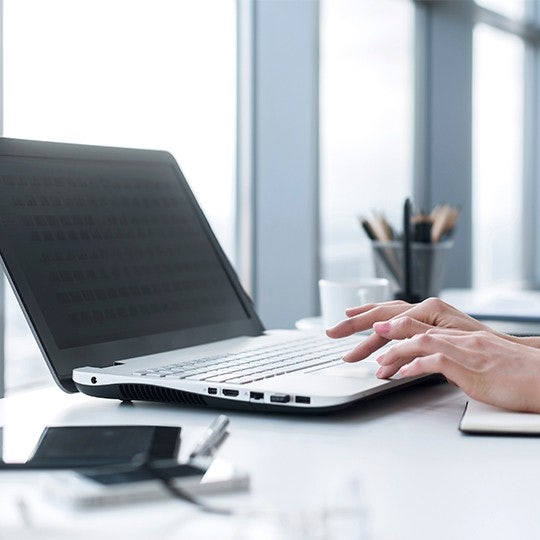 hands working with laptop