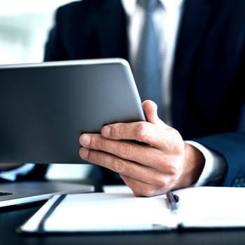 Vikten av informationssäkerhet close up of businessman using a tablet