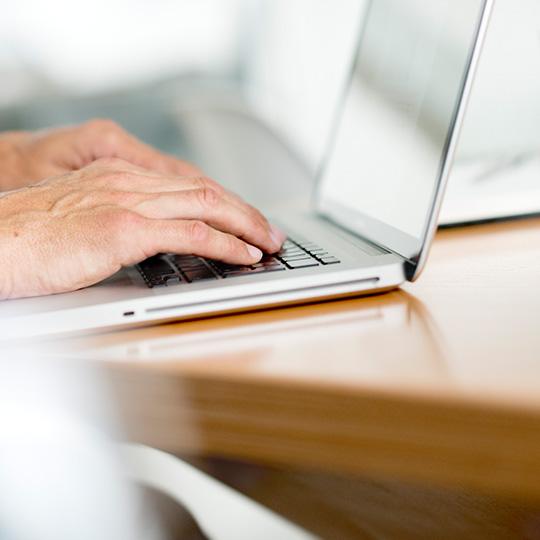 Högsta standarder inom datasäkerhet close up of hands typing on a laptop