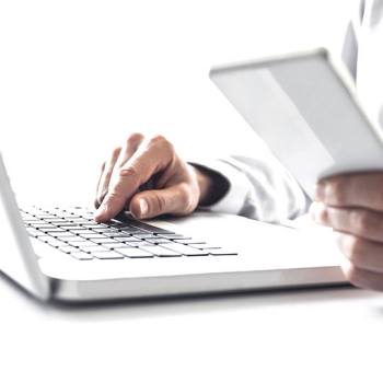 hands typing in a laptop