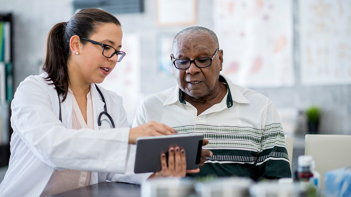 doctor showing patient information on a tablet doctor showing patient information on a tablet