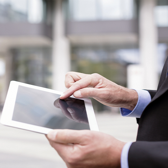 man typing in his tablet